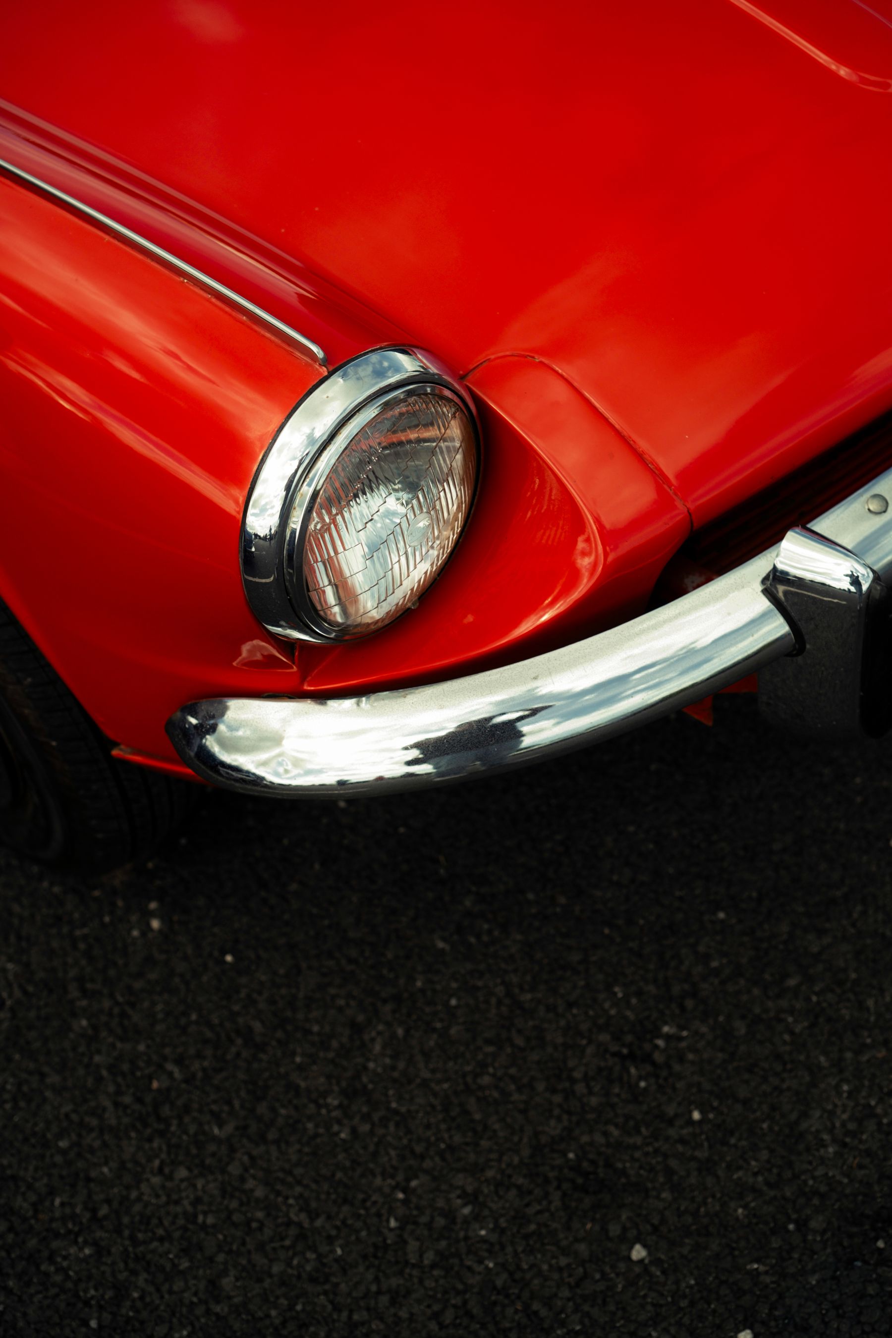 Red classic car with chrome bumper
